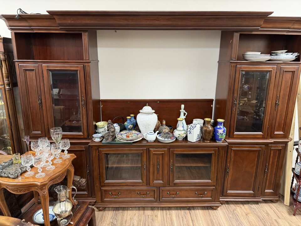 Wooden display cabinet with cloisonne vases, porcelain jars and crystal glasses at Duluth estate sale