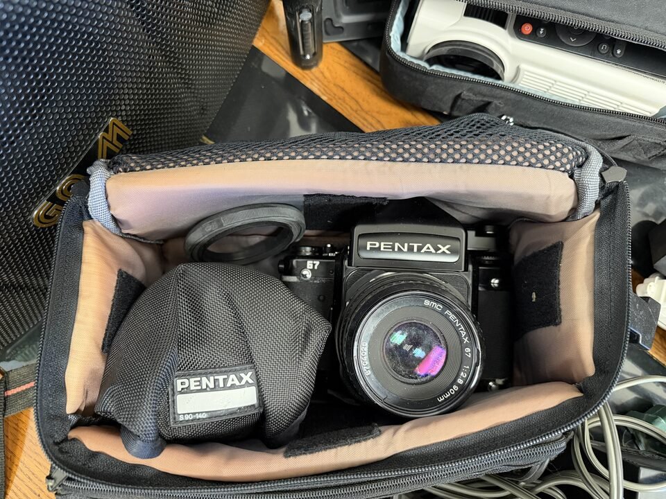 Pentax 67 medium format camera with lens in a padded camera bag